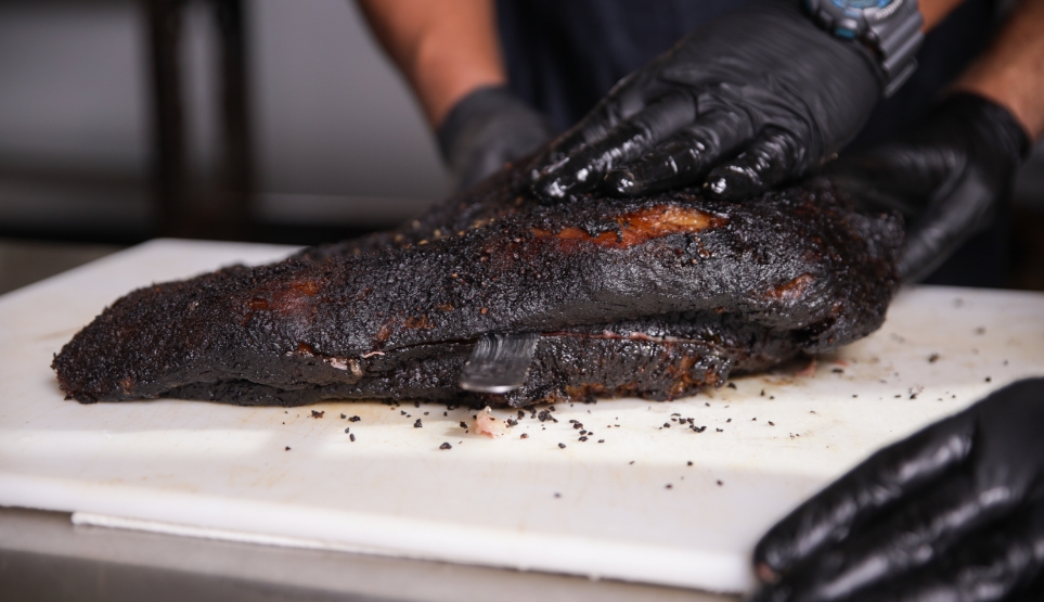 Fatty Layer Being Cut Off a Huge Texas Style Smoked Brisket