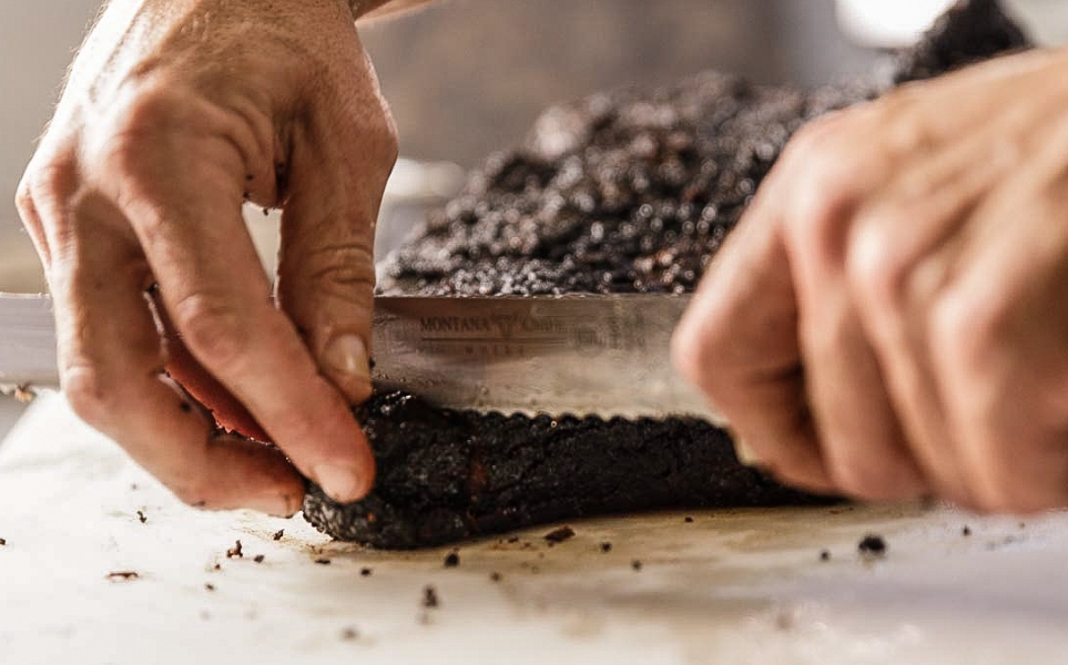 burnt end of brisket being cut off