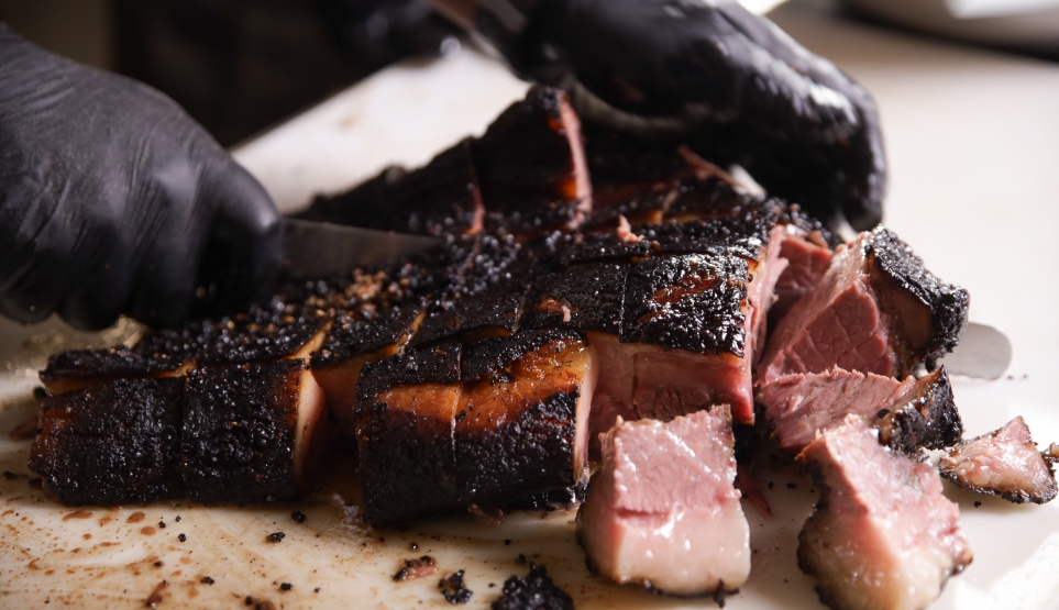 Fatty Layer of Brisket Being Cut into Cubes for Burnt Ends