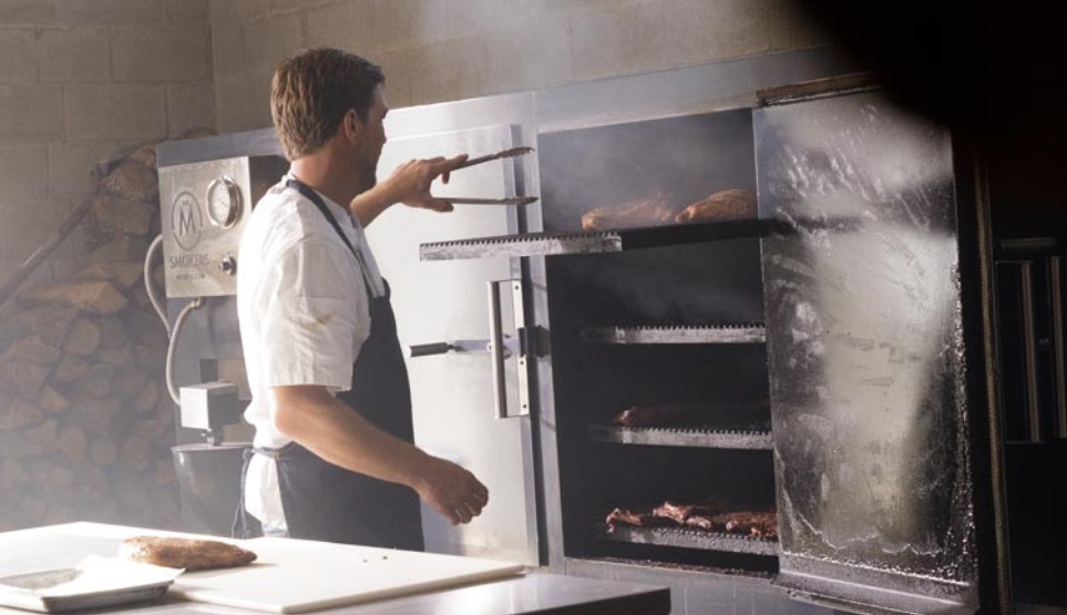 Famed Pitmaster Tim McLaughlin Pulling a Crossbuck BBQ smoked turkey out of Smoker