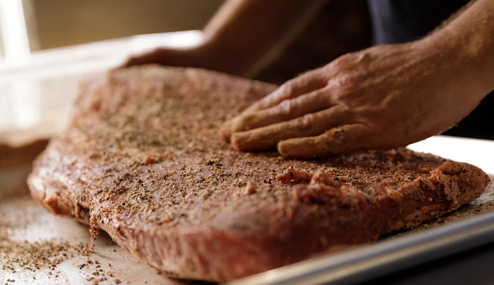 Crossbuck BBQ's brisket being rubbed