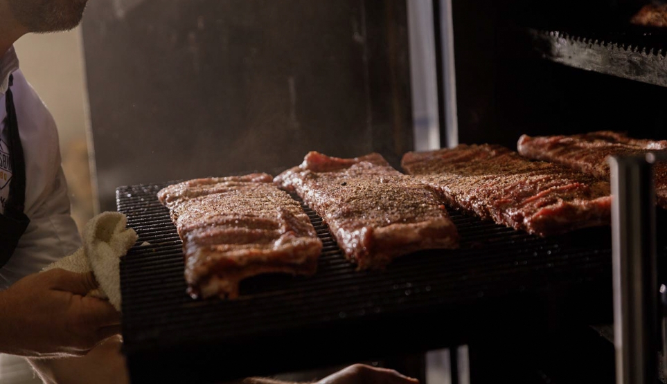 Crossbuck BBQ Ribs being Loaded into Smoker