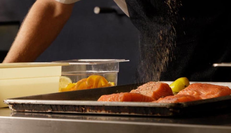 Crossbuck BBQ's Salmon being dusted with freshly-ground citrus zest, house-made from dehydrated lemon