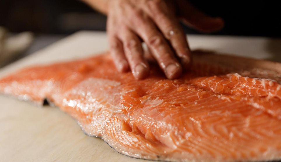 Famed Pitmaster Tim McLaughlin prepping a whole, fresh salmon for smoking