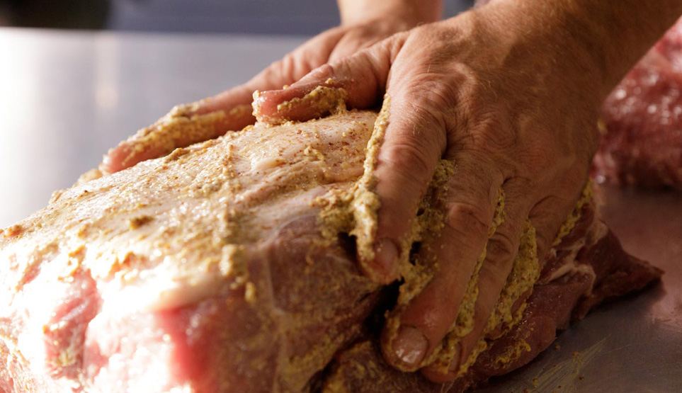 Crossbuck BBQ's pork butt being seasoned