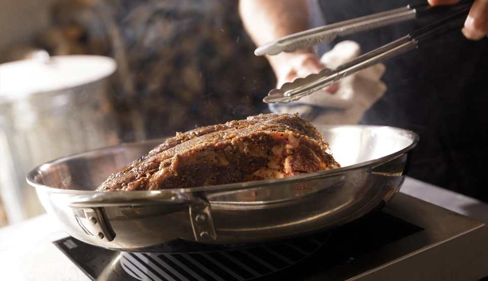 Crossbuck BBQ's Prime Rib being pan seared in bacon fat